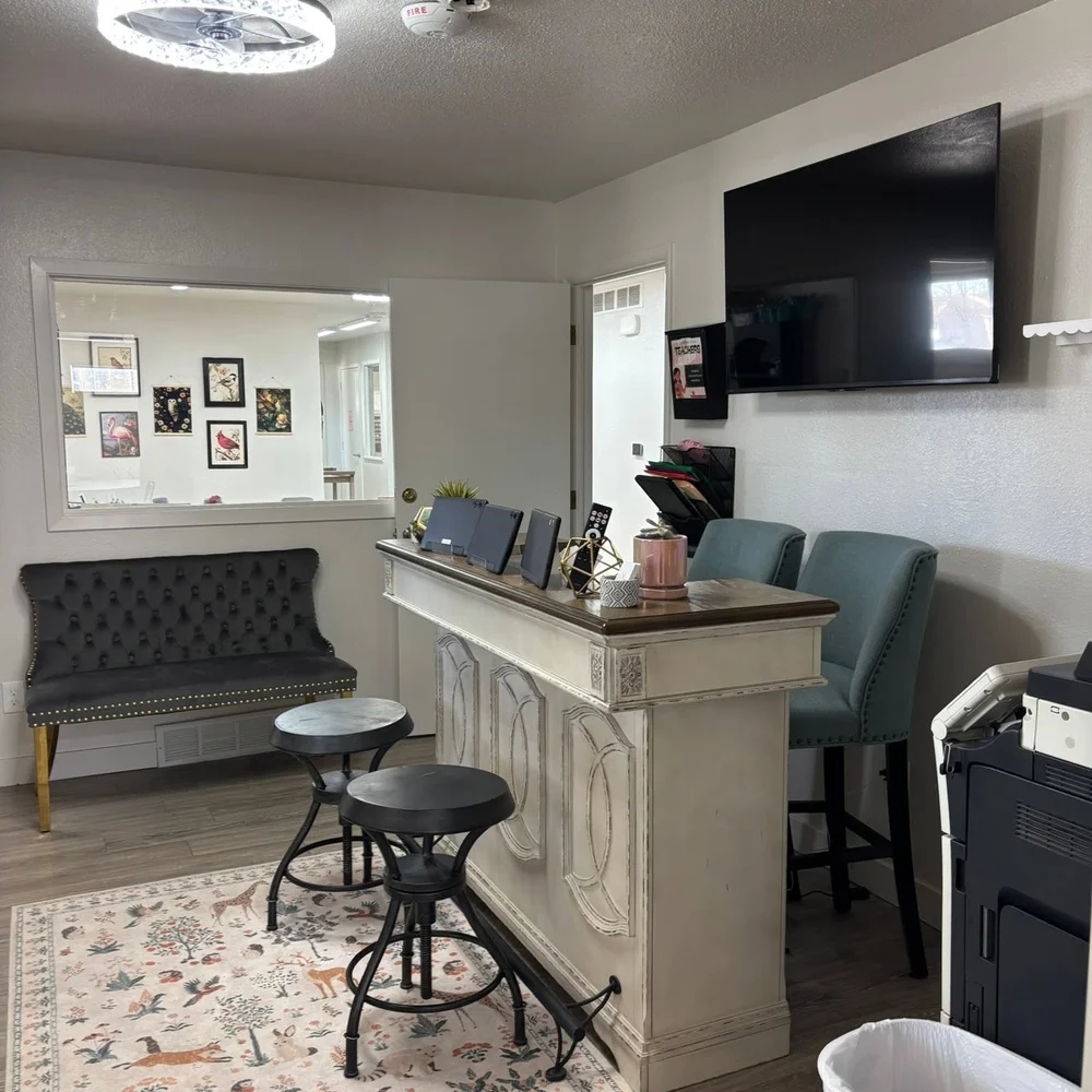 Front desk and welcoming lobby with seating and check-in tablets at The Nest in Earlham, Iowa