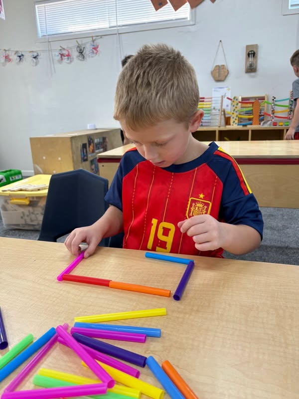 Cardinals school age student building shapes with colorful straws at The Nest